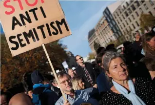  ?? ?? Rally: A protester waves a placard at a demonstrat­ion in Berlin last year