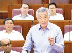  ??  ?? Lee speaks at the special sitting of parliament. — Reuters photo