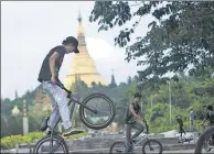  ?? YE AUNG THU / AGENCE FRANCE-PRESSE ?? Cyclists perform stunts in a park in Yangon. Many of the riders’ families want them to stop, but the say the sport keeps them away from drugs and crime.