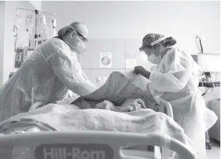  ?? AP Photo/jae C. Hong ?? Regist ered nurses Robin Gooding (left) and Johanna Ortiz treat a Covid-19 patient at Providence Holy Cross Medical Center in the Mission Hills section of Los Angeles on December 22, 2020.