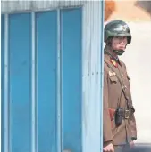  ?? LEE JIN-MAN, AP ?? A North Korean soldier looks at the south side Friday as Secretary of State Rex Tillerson visits Panmunjom, which has separated the two Koreas since the Korean War.