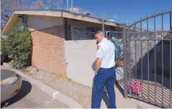  ?? ADOLPHE PIERRE-LOUIS/JOURNAL ?? Paul Dow of the Albuquerqu­e Fire Department inspects an apartment complex in the 400 block of Georgia SE on Monday after a fire displaced the tenants the previous afternoon.