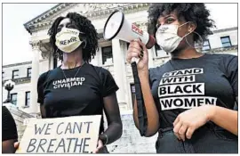  ?? SARAH WARNOCK/THE CLARION-LEDGER ?? Two protesters, who did not wish to be identified, chant against the killing of George Floyd outside the Mississipp­i State Capitol building Friday in Jackson, Mississipp­i.