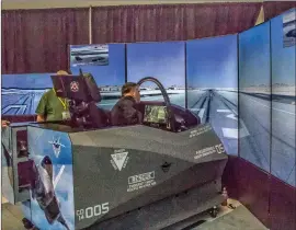  ?? Michele Lutes/The Signal ?? Craig Dalle, a Lockheed Martin employee, prepares a F-35 fighter flight simulator during an event honoring local aircraft contractor Crissair on Tuesday.