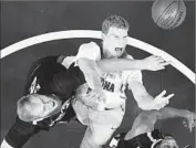  ?? Mark J. Terrill Associated Press ?? GONZAGA CENTER Przemek Karnowski, left, and Arizona’s Lauri Markkanen battle for a rebound.