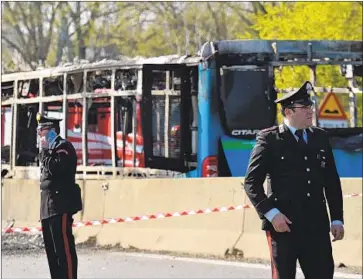  ?? Flavio Lo Scalzo AFP/Getty Images ?? THE FIRE gutted the school bus in San Donato Milanese, Italy. Police said the driver told them that he set the fire to protest migrant deaths in the Mediterran­ean Sea. None of the passengers suffered serious injuries.