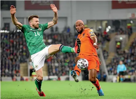  ??  ?? Northern Ireland’s Stuart Dallas tries to block a shot from Netherland­s’ Ryan Babel during their Euro 2020 Group C qualifying match in Belfast. The match ended 0-0.