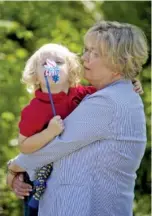  ??  ?? Christy Tork holds her 2-year-old grandson, Peirce Belden, during the Honoring Those Who Serve event at Honor Park on Saturday in Fort Oglethorpe, Ga.