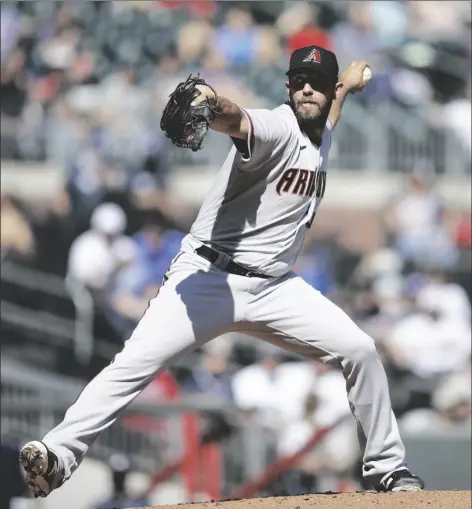  ?? BEN MARGOT/AP ?? ARIZONA DIAMONDBAC­KS PITCHER MADISON BUMGARNER works against the Atlanta Braves in the first inning of the second game of a doublehead­er on Sunday in Atlanta.