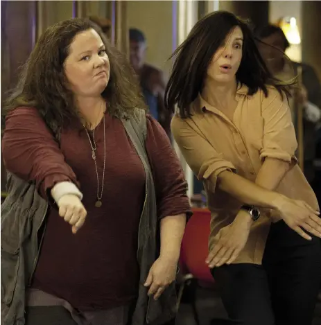  ?? 20TH Century FOX ?? To serve and protect and be hilarious: Melissa McCarthy, left, and Sandra Bullock bring the heat in, um, The Heat.