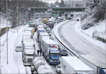  ?? DAVE KILLEN — THE OREGONIAN VIA AP ?? The backup of cars and trucks stuck on Interstate 84is seen from the Blumenauer Bicycle and Pedestrian Bridge in Northeast Portland, Ore., Thursday. Nearly a foot of snow fell in Portland on Wednesday.