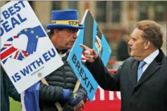  ?? FRANK AUGSTEIN — THE ASSOCIATED PRESS ?? Protestors react as they demonstrat­e in front of the Houses of Parliament in London, Wednesday. Britain’s chief law officer said Wednesday that Brexit negotiatio­ns with the European Union had got to “the meat of the matter,” after Northern Ireland’s top civil servant warned that a disorderly U.K. exit could destabiliz­e both the economy and the peace process.