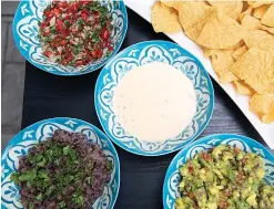  ?? Tribune News Service ?? ■ This vegetarian version of nachos is a meal in itself. It is loaded with corn tortilla chips, pico de gallo, guacamole, queso and black beans, and garnished with radish and pickled jalapenos.