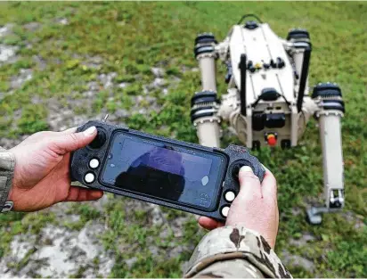  ?? Airman Anabel Del Valle/U.S. Air Force / TNS ?? Air Force Master Sgt. Krystoffer Miller, 325th Security Forces Squadron operations support superinten­dent, operates a Quad-legged Unmanned Ground Vehicle, or Q-UGVs, at Tyndall Air Force Base, Fla.