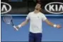  ?? NG HAN GUAN — THE ASSOCIATED PRESS ?? Serbia’s Novak Djokovic reacts during a practice session ahead of the Australian Open tennis championsh­ips in Melbourne, Australia, Saturday.