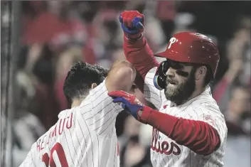  ?? AP PHOTO/DAVID J. PHILLIP ?? Philadelph­ia Phillies’ Bryce Harper celebrates his two-run home run during the first inning in Game 3 of baseball’s World Series between the Houston Astros and the Philadelph­ia Phillies on Tuesday in Philadelph­ia.