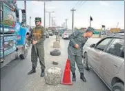  ?? AFP ?? Afghan policemen stand guard at a checkpoint along the road in Kabul on Saturday.