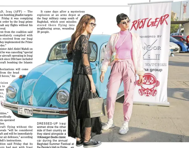  ?? AFP ?? DRESSED-UP Iraqi women show the other side of their country as they stand alongside a Volkswagen Beetle classic car during the annual Baghdad Summer Festival at the People’s Hall on Friday.