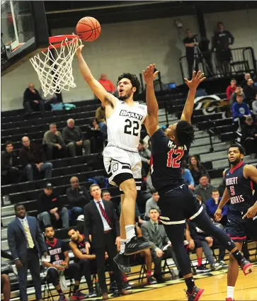  ?? Photos by Ernest A. Brown ?? Bryant junior guard Adam Grant (11) kept his team in Saturday’s game with Robert Morris by hitting three early 3-pointers, but Grant, freshman Joe Kasperzyk (11) and the Bulldogs were bested, 79-65, by the Colonials.