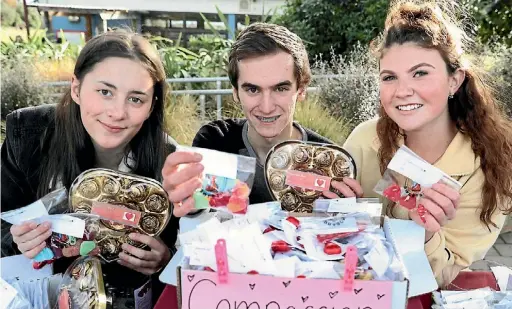  ?? PHOTO: MARION VAN DIJK/FAIRFAX NZ ?? Nayland College level 2 sociology students Tiahna Kingi, Felix Chrysostom­ouKoed and Isobel NewmarchCh­apman sell heart-shaped confection­ery on Compassion Day to raise funds for Syria.