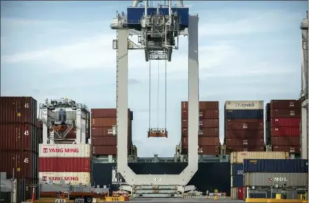  ?? STEPHEN B. MORTON — THE ASSOCIATED PRESS FILE ?? A ship to shore crane prepares to load a 40-foot shipping container onto a container ship at the Port of Savannah in Savannah, Ga. After galloping along for the past two years, the global economy is showing signs of weakening, with the United States, China and Europe all facing the rising threat of a slowdown. Few economists foresee an outright global recession within the next year. But the synchroniz­ed growth that powered most major economies since 2017 appears to be fading.