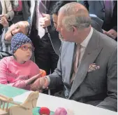  ??  ?? The Prince of Wales meets 11-year-old Maria Mihai during a visit to the Hospices of Hope in Bucharest, and (below) Charles and Camilla in Florence on the first day of a week-long trip to Italy