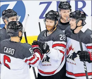  ?? THE ASSOCIATED PRESS ?? Team Canada forward Claude Giroux, middle, celebrates his goal with teammates during a friendly internatio­nal ice hockey game between Switzerlan­d and Canada Tuesday in Geneva, Switzerlan­d,