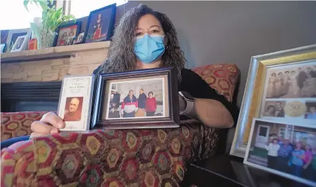  ?? ADOLPHE PIERRE-LOUIS/JOURNAL ?? Alicia Rodriguez and four family members all contracted COVID-19 last month, but her parents and one brother didn’t survive the virus, dying within weeks of each other. Rodriguez sits in her Albuquerqu­e home showing photos of her parents, brother and uncle who have all died from the virus.