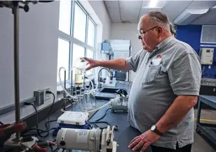  ?? PHOTOS BY GABRIELA CAMPOS/THE NEW MEXICAN ?? Danny Carter, a chemist at the Buckman Direct Diversion’s water treatment plant, demonstrat­es Wednesday in his lab how to measure undissolve­d solids from water taken from the Rio Grande. Demand from county customers in 2023 sat at roughly one-third of the county’s supply.