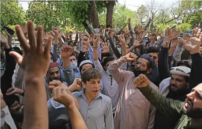  ?? Picture: AFP ?? HANDS UP. Traders shout anti-France slogans during a nationwide strike yesterday to show solidarity with the Tehreek-e-Labbaik Pakistan party after its leader was detained.