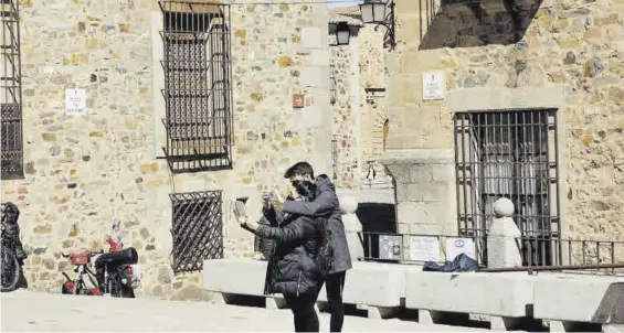  ?? JOSE PEDRO JIMÉNEZ ?? Una pareja de turistas se hace un `selfie' en la ciudad monumental de Cáceres durante el pasado puente de San José.