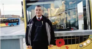  ??  ?? Award-winning bus driver Brian McDowall in front of his bus.