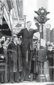  ?? AP ?? Wadlow demonstrat­es he is nearly as tall as this New York stoplight in April 1937. Wadlow hated publicity but out of necessity derived financial benefit from it. He had hopes of becoming a lawyer.