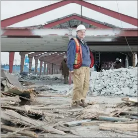  ?? RICHARD LAM/PNG ?? George Robson stands amid materials to be recycled from the B.C. Rail station and made into a giant barn.