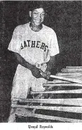  ?? (Photo courtesy of the Garland County Historical Society) ?? Hot Springs Bathers outfielder Uvoyd Reynolds selects a bat from the bat rack in 1954. Reynolds was the first African American to play in the Cotton States League.