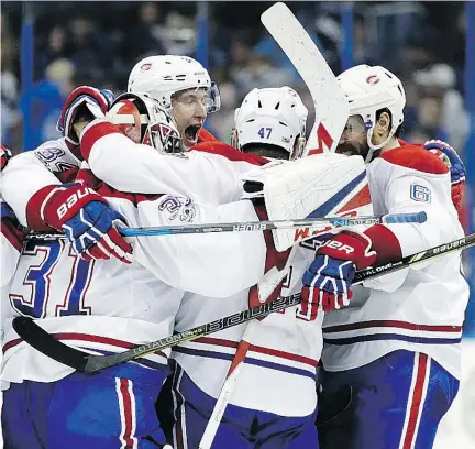  ?? CHRIS O’MEARA/THE ASSOCIATED PRESS ?? Canadiens right wing Alexander Radulov, centre, celebrates with teammates after defeating the Tampa Bay Lightning in overtime Saturday in Tampa, Fla. The No. 1 line of Phillip Danault between Max Pacioretty and Radulov combined for five points