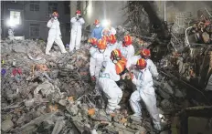  ?? Reuters ?? Rescue workers carry a survivor yesterday on a stretcher almost six days after a building collapsed in Changsha.