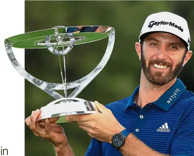  ?? — AFP ?? Worth the sweat: American Dustin Johnson posing with the trophy after defeating compatriot Jordan Spieth in a playoff to win the Northern Trust on Sunday.