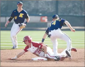  ?? Craven Whitlow/Special to the News-Times ?? Theft in progress: Arkansas second baseman Carson Shaddy (20) slides in safely for a stolen base against Kent State Friday afternoon at Baum Stadium in Fayettevil­le. The Hogs won the first game of Friday's doublehead­er 7-2, but the Golden Flashes won...