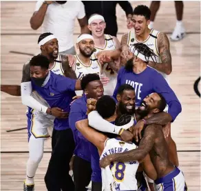  ?? AP ?? Champions: Los Angeles Lakers players celebratin­g after beating Miami Heat 106-93 in Game 6 of basketball’s NBA Finals on Sunday. —