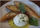  ??  ?? The Cowgirl Creamery burrata is drizzled with lemon olive oil and served with country bread.