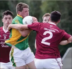  ??  ?? Brian O’Neill of Rathgarogu­e-Cushinstow­n is held up by David Deering (Castletown) in Sunday’s JFC Group A game in Hollymount.