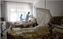  ?? EVGENIY MALOLETKA / AP / FILE ?? Medical staff treat a patient with coronaviru­s at an ICU of the city hospital 1 in Rivne, Ukraine. Ukraine is suffering through a surge in coronaviru­s infections, along with other parts of Eastern Europe and Russia.