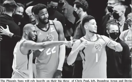  ??  ?? The Phoenix Suns will rely heavily on their big three of Chris Paul, left, Deandrae Ayton and Devin Booker to win their first NBA Finals in over two decades.