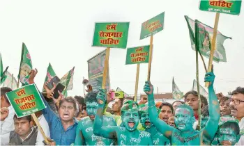  ?? —PTI ?? Rashtriya Janata Dal (RJD) supporters during the Berozgari Hatao Yatra’, in Patna on Sunday. The RJD said if it is voted to power in Bihar, it will introduce a domicile policy and reserve 85% government jobs for Bihar natives.
