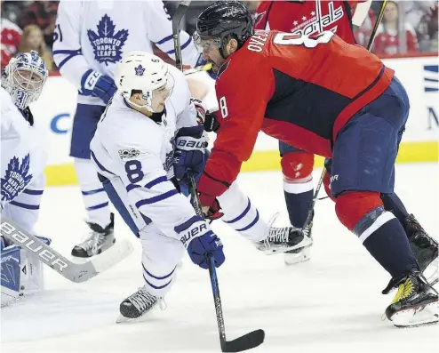  ?? NICK WASS / THE ASSOCIATED PRESS ?? Alex Ovechkin of the Capitals pushes Maple Leafs defenceman Connor Carrick in Tuesday night’s game.