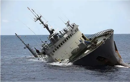  ??  ?? Going under: The ‘Thunder’ listing to starboard as it sinks in the waters of Sao Tome and Principe. — AFP