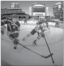  ?? AP/ADAM HUNGER ?? Outdoor hockey
New York Rangers left wing Jimmy Vesey (26) battles for the puck with Buffalo Sabres center Jack Eichel (15) in the NHL’s Winter Classic at Citi Field in New York. J.T. Miller scored the game-winning, power-play goal with 2:43 left in...