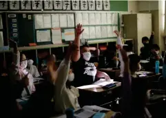  ??  ?? Kyuta raises his hand to answer a question at Meiji elementary school