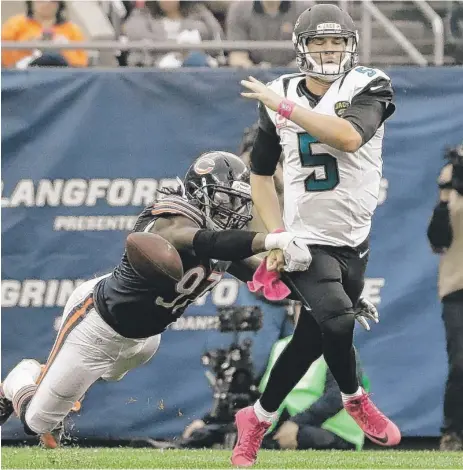  ??  ?? Bears outside linebacker Willie Young strips the ball from Jaguars quarterbac­k Blake Bortles during the second half of a game last season. | AP
